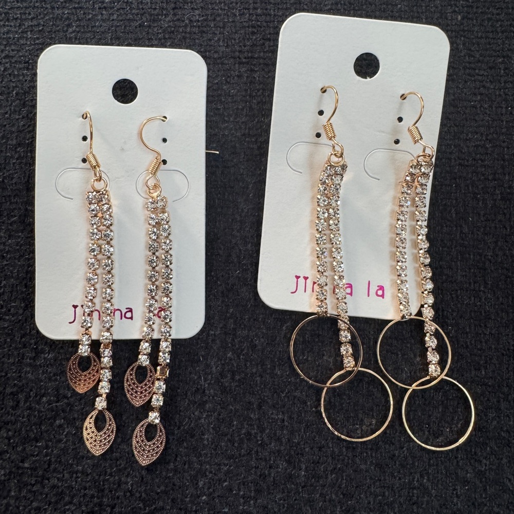 Set of 2 gold tone with faux diamond dangle earrings.